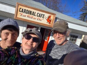 happy people in front of restaurant sign